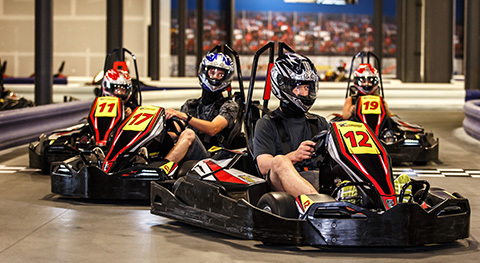 A group of kart racers get ready to cross the finish line